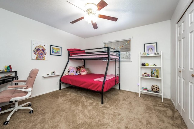 carpeted bedroom featuring ceiling fan, a closet, and baseboards