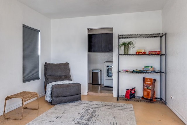 sitting room with washer / dryer and concrete floors