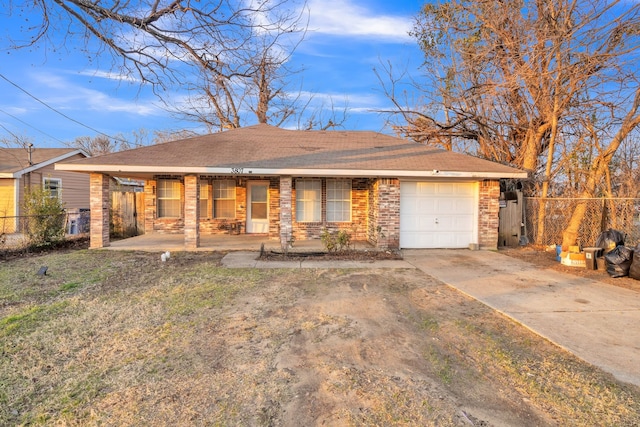 single story home with a garage, a front yard, and covered porch