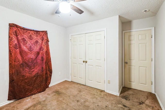 unfurnished bedroom featuring ceiling fan, light colored carpet, a closet, and a textured ceiling