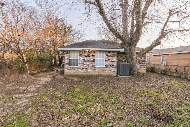 rear view of property featuring central air condition unit