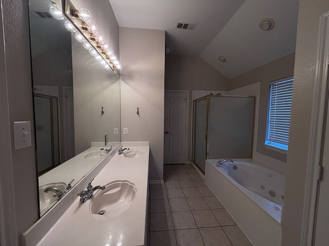 full bath with a tub with jets, tile patterned flooring, and a sink