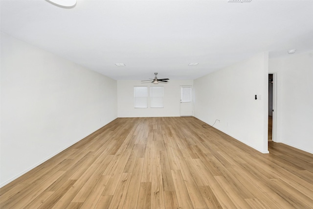 unfurnished living room featuring ceiling fan and light hardwood / wood-style floors