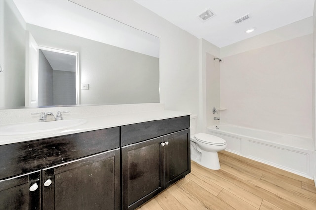 full bathroom featuring vanity, toilet, shower / bath combination, and hardwood / wood-style floors