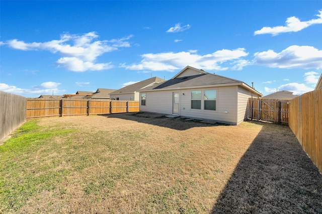 back of house with a lawn