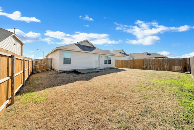 back of property featuring a lawn