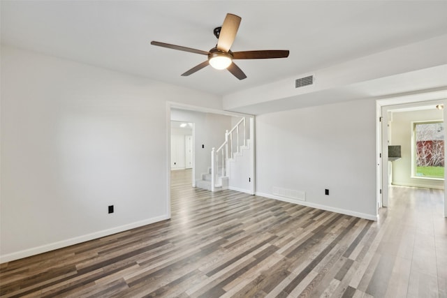 unfurnished living room with wood-type flooring and ceiling fan