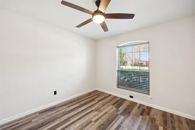 empty room featuring dark wood-type flooring and ceiling fan