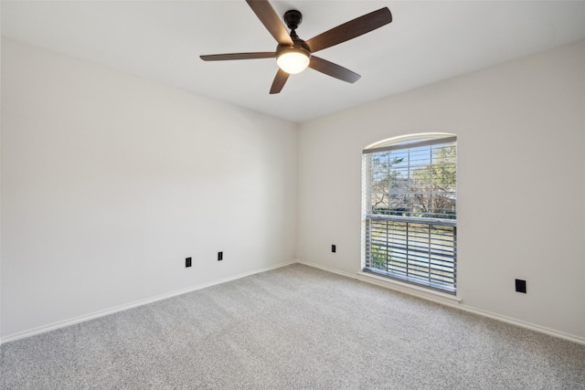 carpeted spare room featuring ceiling fan