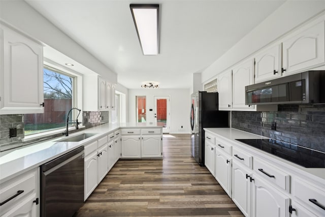 kitchen featuring sink, black appliances, dark hardwood / wood-style floors, and white cabinets