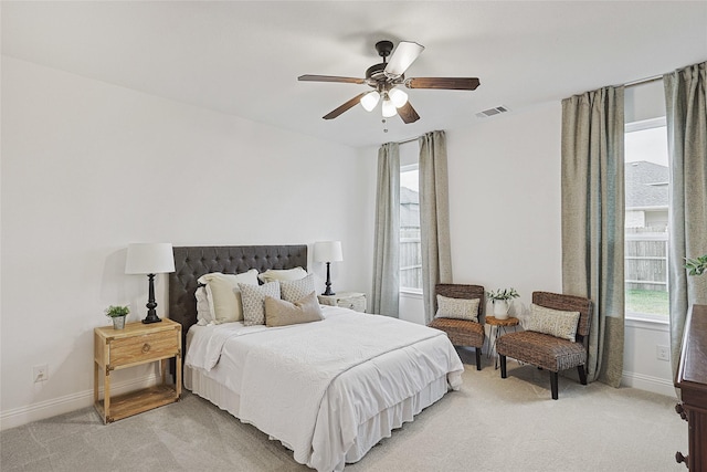 bedroom with ceiling fan and light carpet