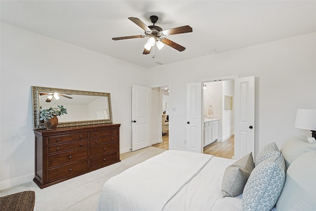 bedroom featuring ceiling fan and connected bathroom