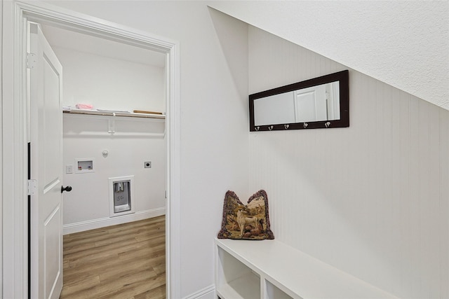 laundry room featuring gas dryer hookup, hookup for a washing machine, light hardwood / wood-style flooring, and hookup for an electric dryer