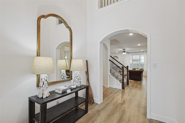 hallway with light hardwood / wood-style floors