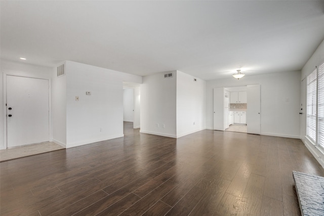 unfurnished living room featuring dark wood-type flooring