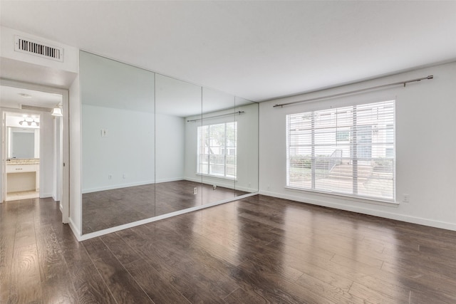 spare room with dark hardwood / wood-style floors