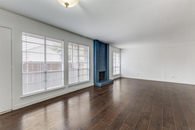 unfurnished living room with a fireplace and dark hardwood / wood-style flooring