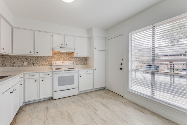 kitchen featuring backsplash, white cabinets, and white range with electric stovetop