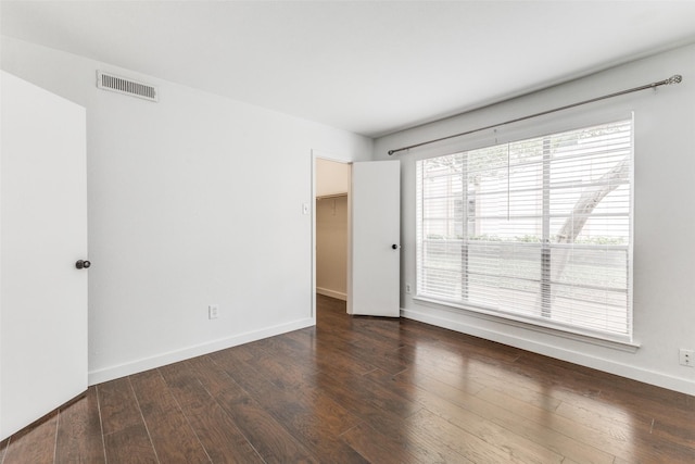 empty room with dark hardwood / wood-style floors