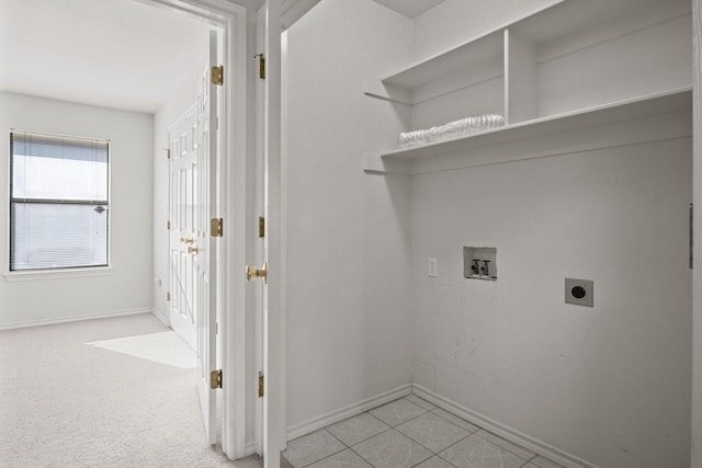 clothes washing area featuring light colored carpet, hookup for a washing machine, and electric dryer hookup