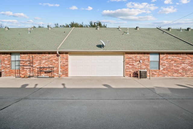 view of front of home with a garage and central AC unit