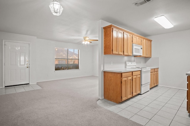 kitchen with ceiling fan, white appliances, and light colored carpet