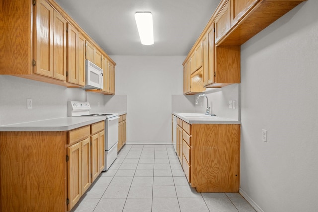 kitchen featuring light tile patterned flooring, sink, and white appliances