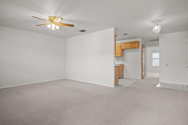 empty room featuring light colored carpet and ceiling fan