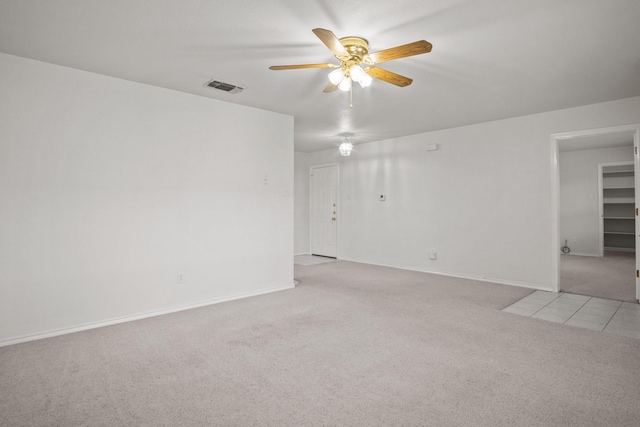 carpeted spare room featuring ceiling fan