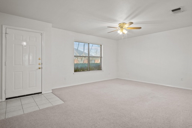 carpeted entrance foyer with ceiling fan