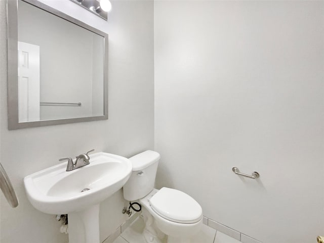 bathroom featuring tile patterned flooring, sink, and toilet