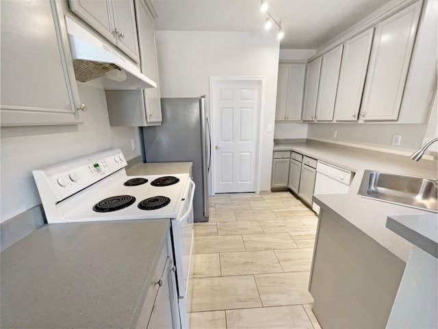 kitchen with gray cabinetry, sink, white appliances, and rail lighting