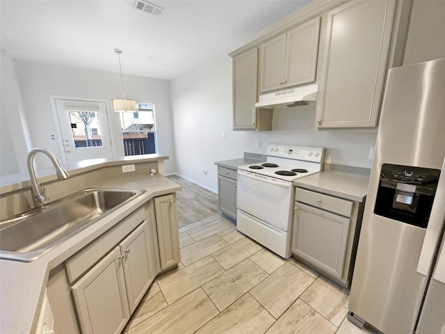 kitchen featuring stainless steel refrigerator with ice dispenser, sink, gray cabinetry, decorative light fixtures, and electric range