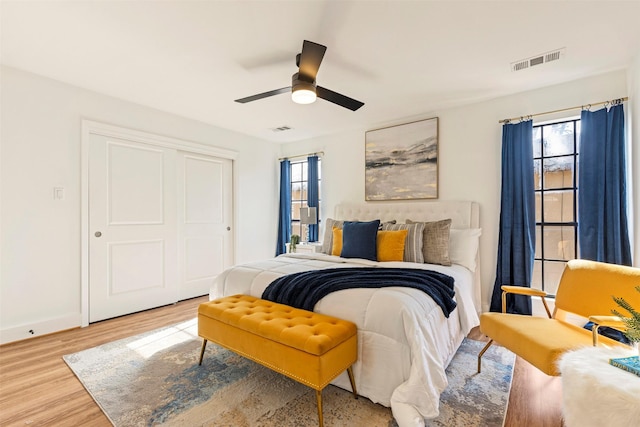 bedroom with hardwood / wood-style flooring, a closet, and ceiling fan