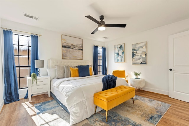 bedroom with ceiling fan and light hardwood / wood-style flooring