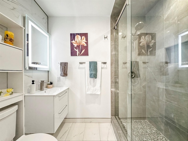 bathroom with an enclosed shower, vanity, and toilet