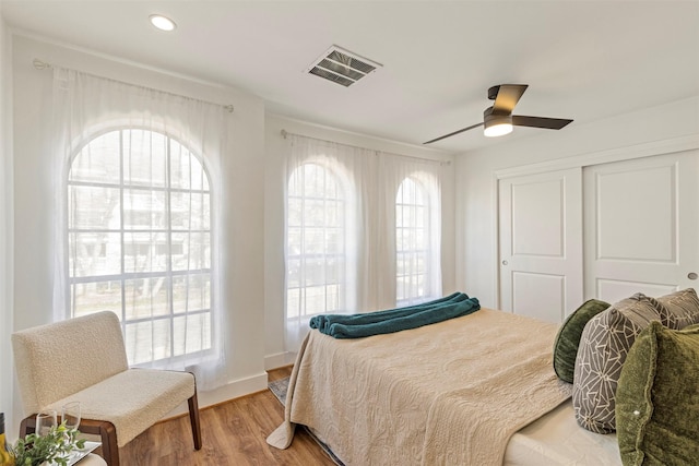 bedroom with ceiling fan, hardwood / wood-style floors, and a closet