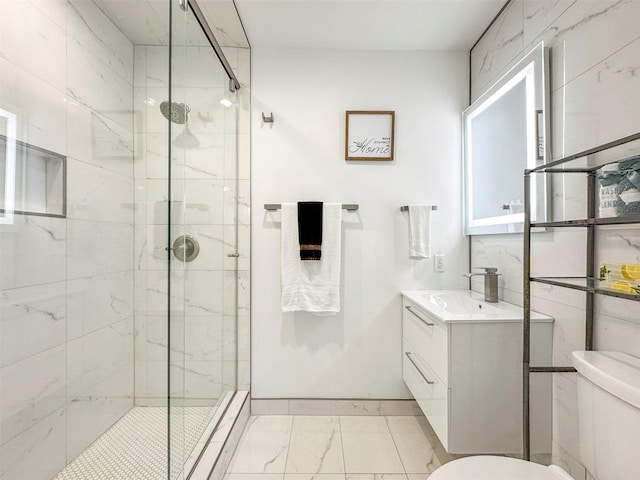 bathroom with an enclosed shower, vanity, and toilet