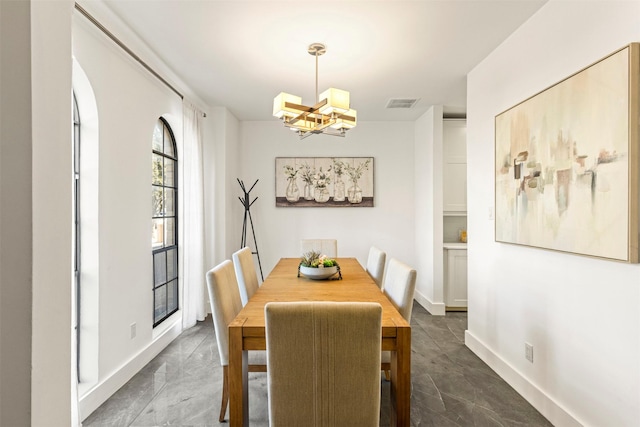 dining space featuring an inviting chandelier