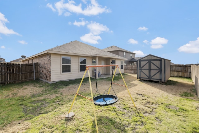 back of property featuring a playground, a lawn, and a storage unit