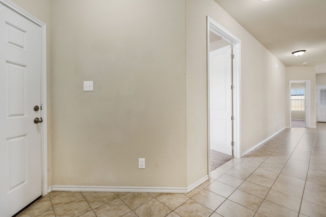 hallway featuring light tile patterned floors