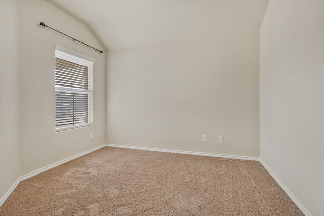 unfurnished room featuring vaulted ceiling and carpet flooring