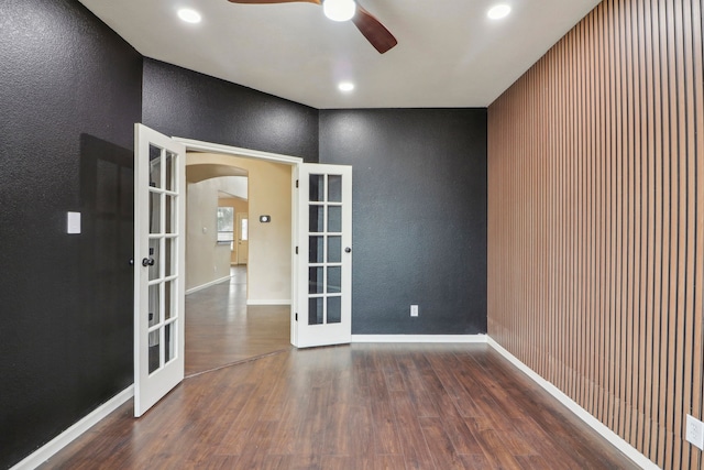 spare room with ceiling fan, dark hardwood / wood-style flooring, and french doors