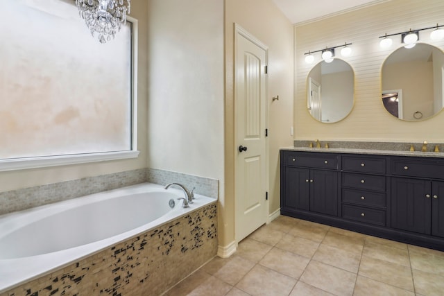 bathroom with vanity, a relaxing tiled tub, and tile patterned floors