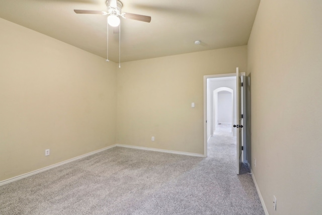 empty room featuring light colored carpet and ceiling fan