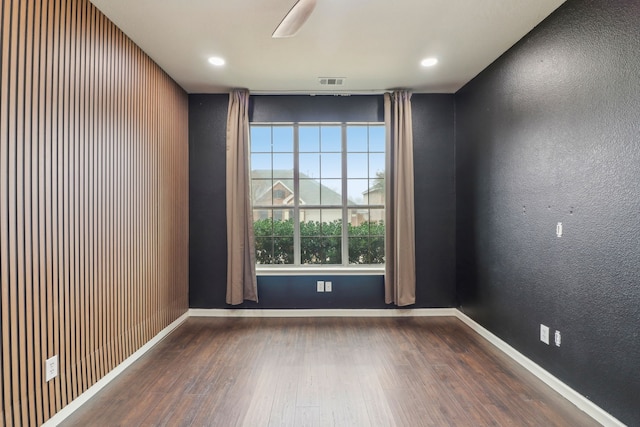 unfurnished room with dark hardwood / wood-style flooring