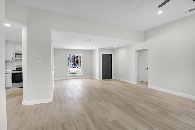 unfurnished living room with ceiling fan and light wood-type flooring