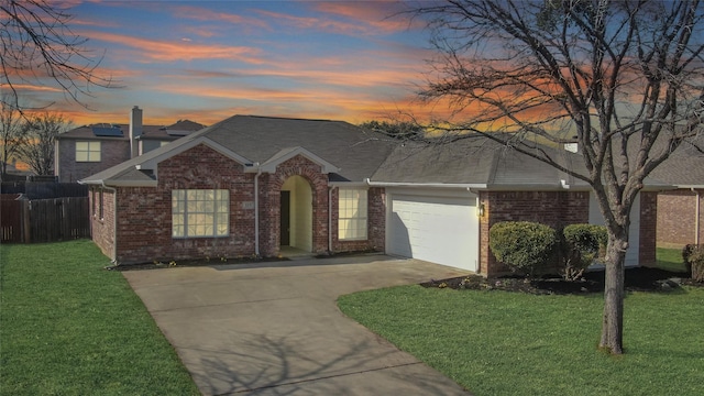 view of front of property with a front lawn, an attached garage, brick siding, and driveway