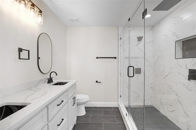 bathroom featuring vanity, toilet, and an enclosed shower