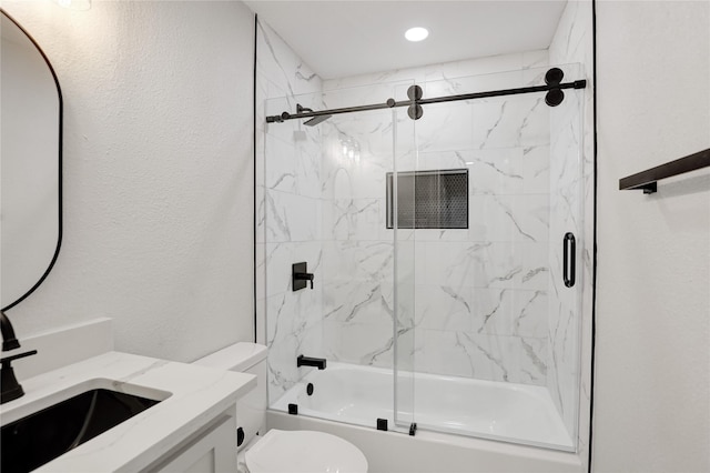 full bathroom with vanity, combined bath / shower with glass door, and toilet